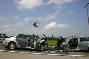 Two vehicles crashed apparently head-on Friday. In the photo, one of the four helicopters departs with an injured victim. Copyright 2015, River Raisin Publications, Inc.