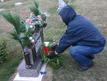 Lloyd Pitney puts a wreath on the grave of his cousin, veteran  Staff Sgt. Bryan Pitney, a Deerfield, Michigan, native. (Copyright 2015, River Raisin Publications, Inc. All rights reserved)